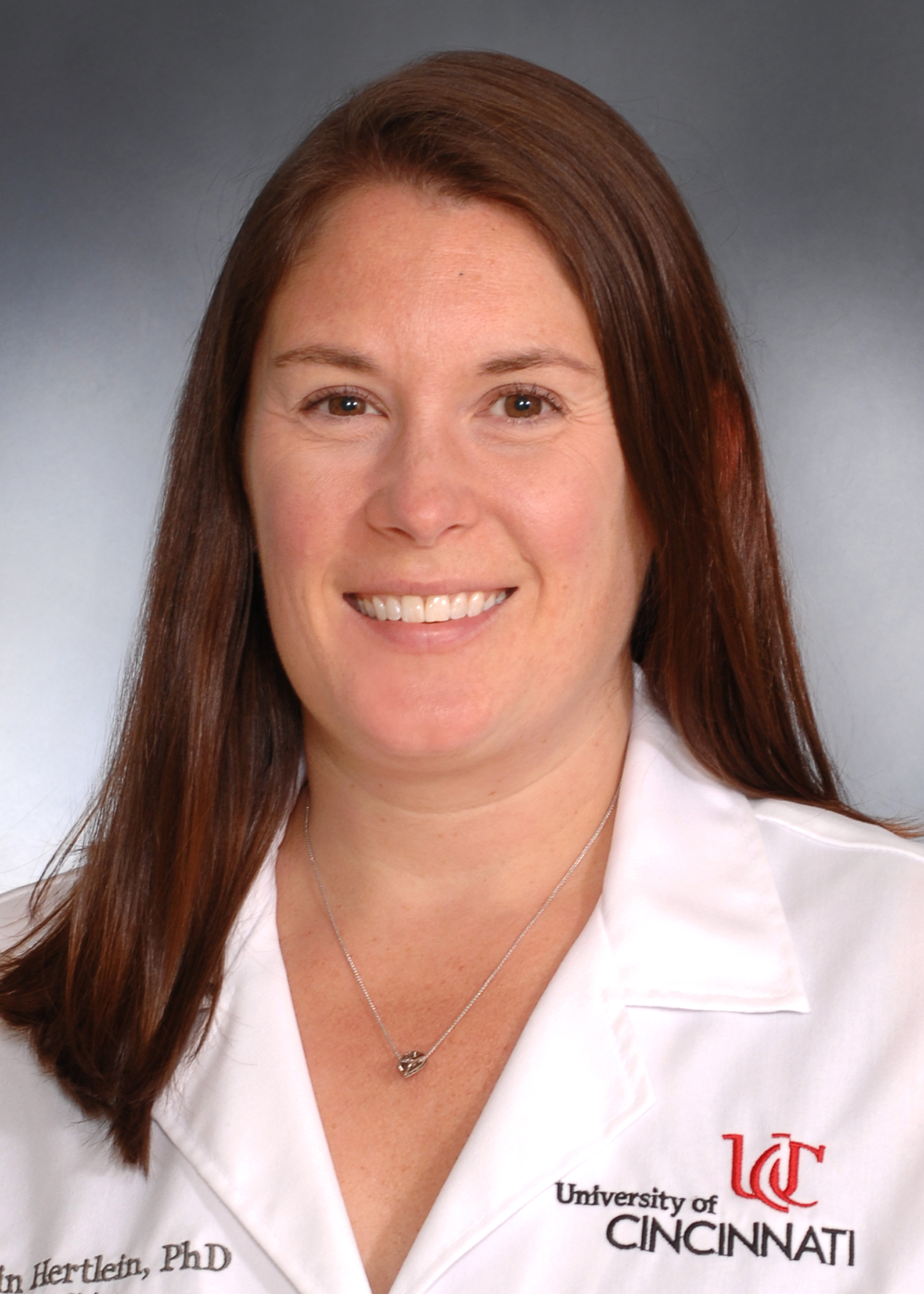 Photo of Dr. Erin Hertlein in a UC lab coat