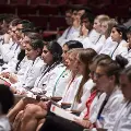people in white coats seated