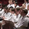 people in white coats seated