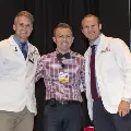 Three people pose for a photo