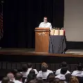 speaker in lab coat at podium