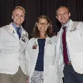 three people smiling