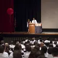 two people in lab coats with crowd
